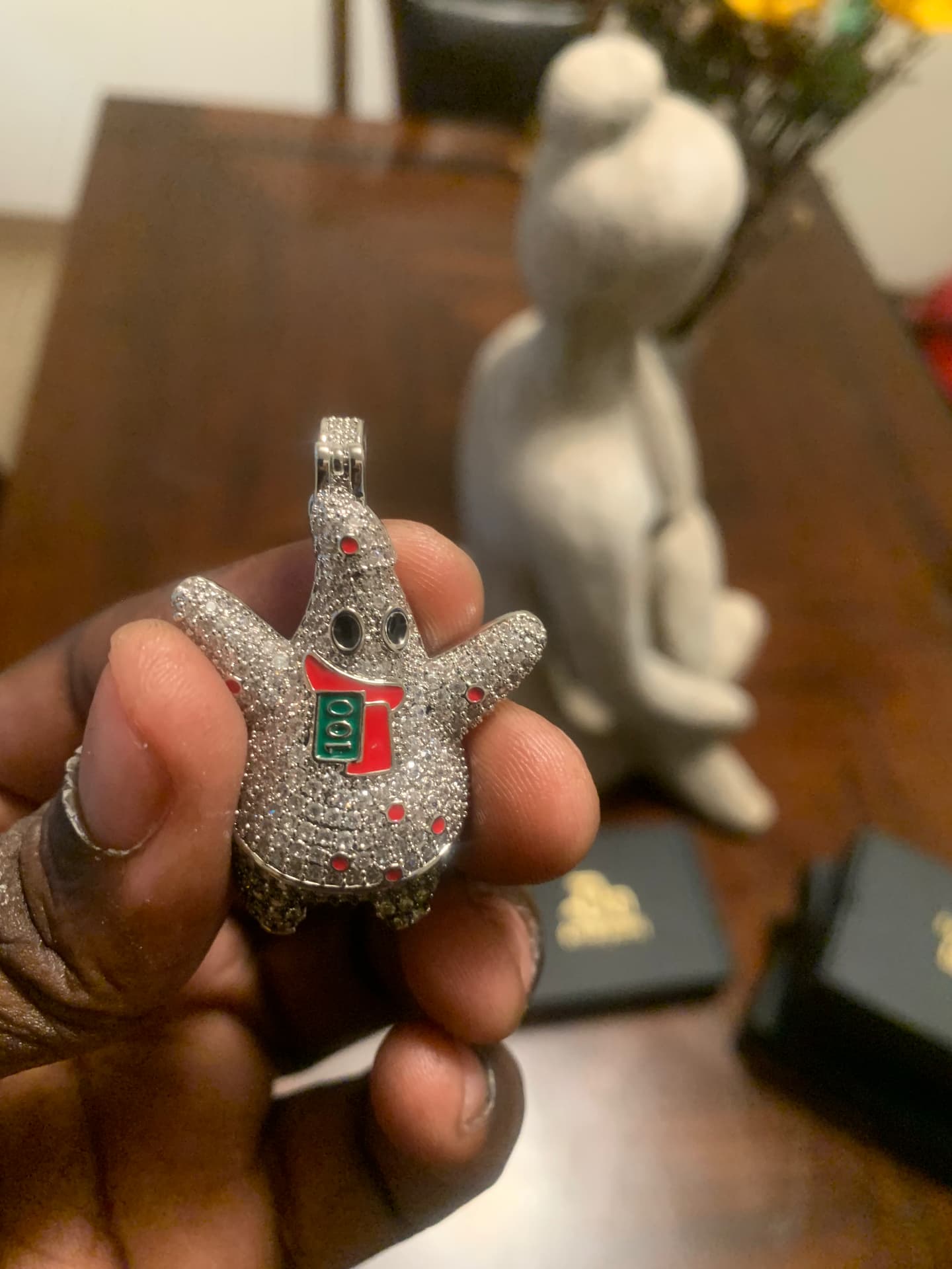 Close view of the iced character pendant