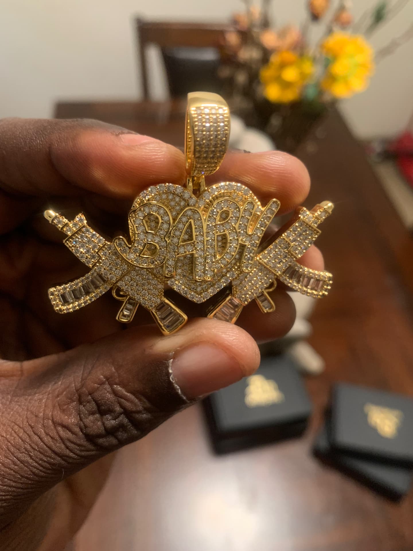 Close view of the BABY heart rifle pendant