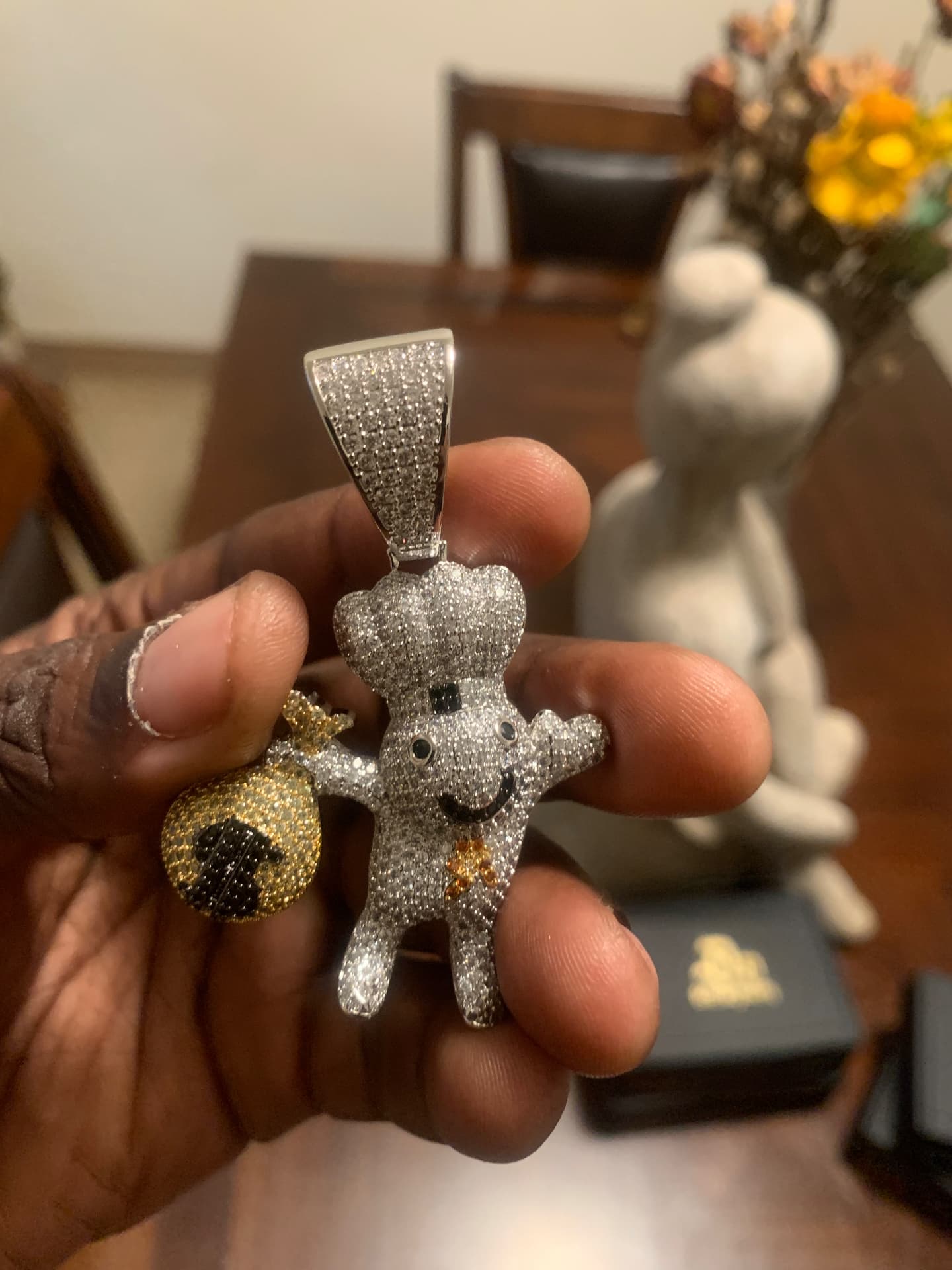 Silver iced chef pendant holding a gold money bag