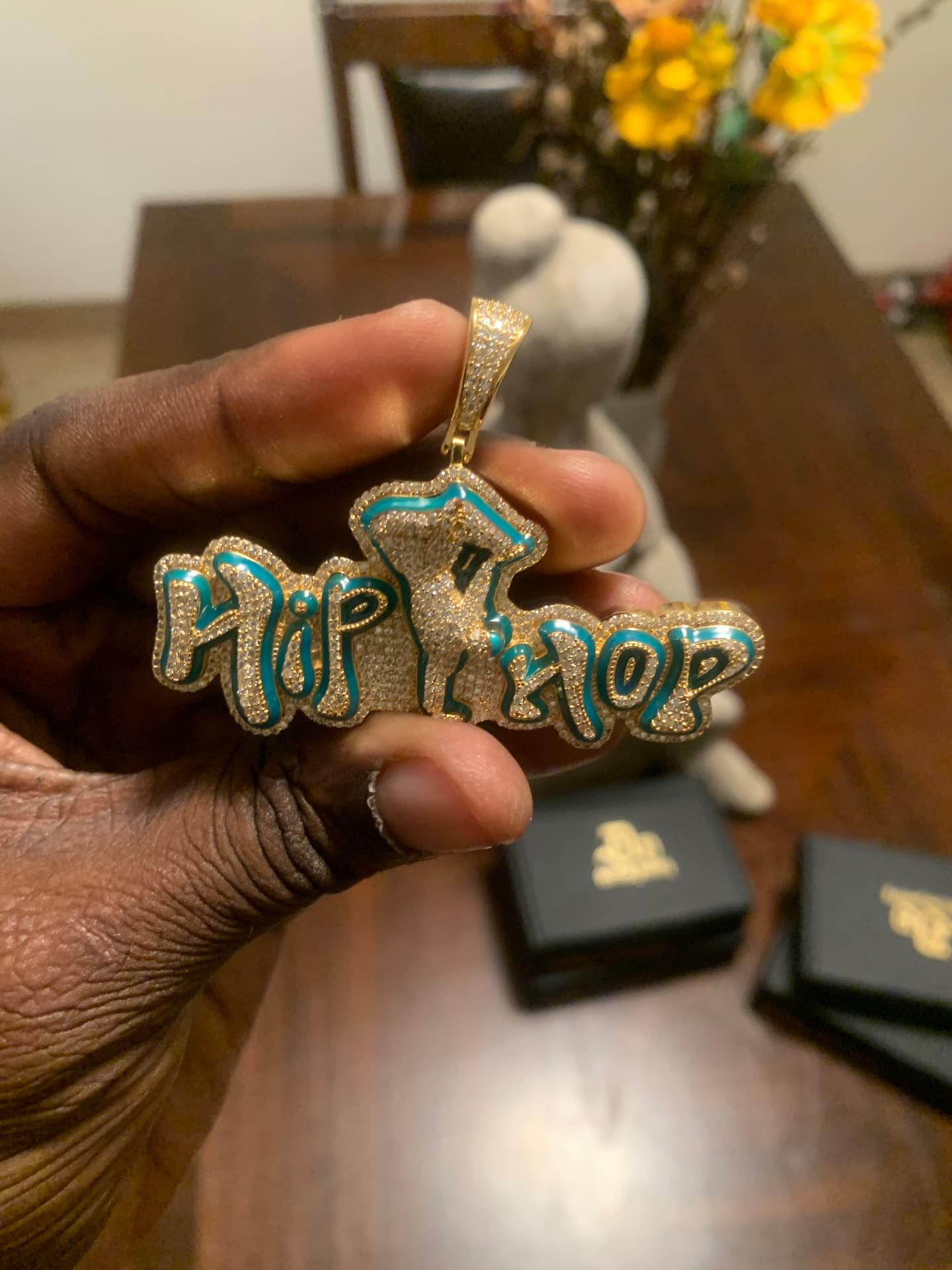 Gold-tone iced Hip Hop pendant with turquoise enamel