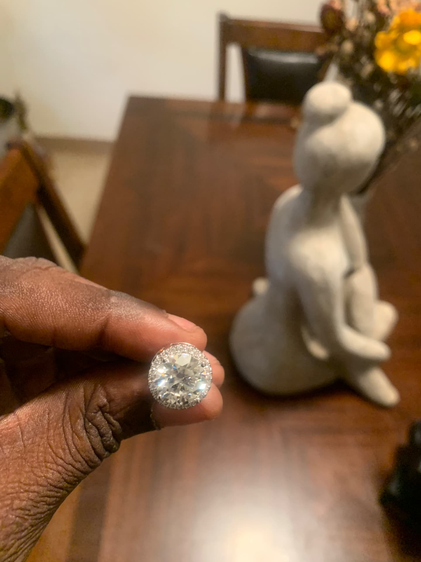 Close view of one round moissanite halo stud