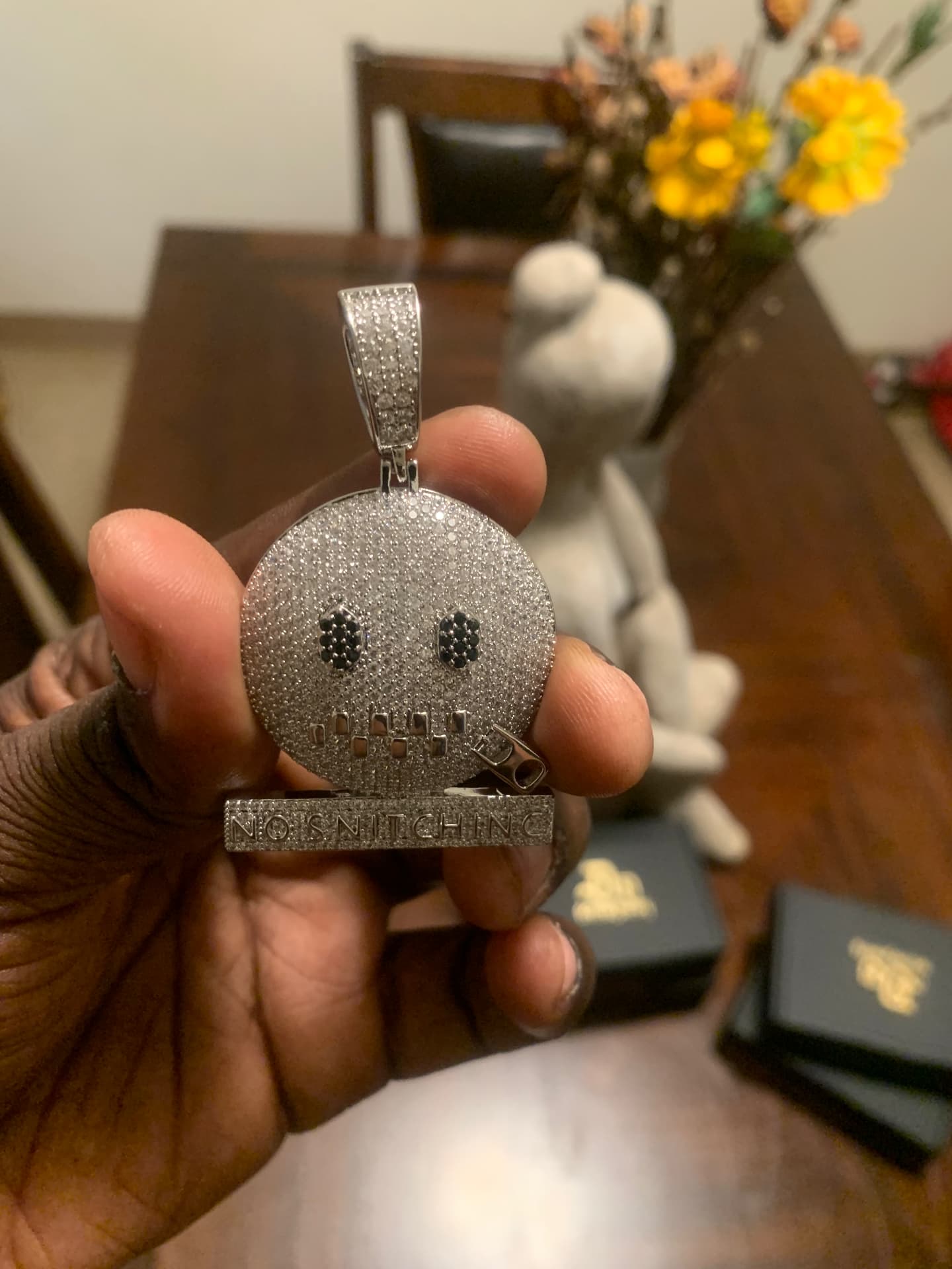 Silver No Snitching pendant with black stone eyes